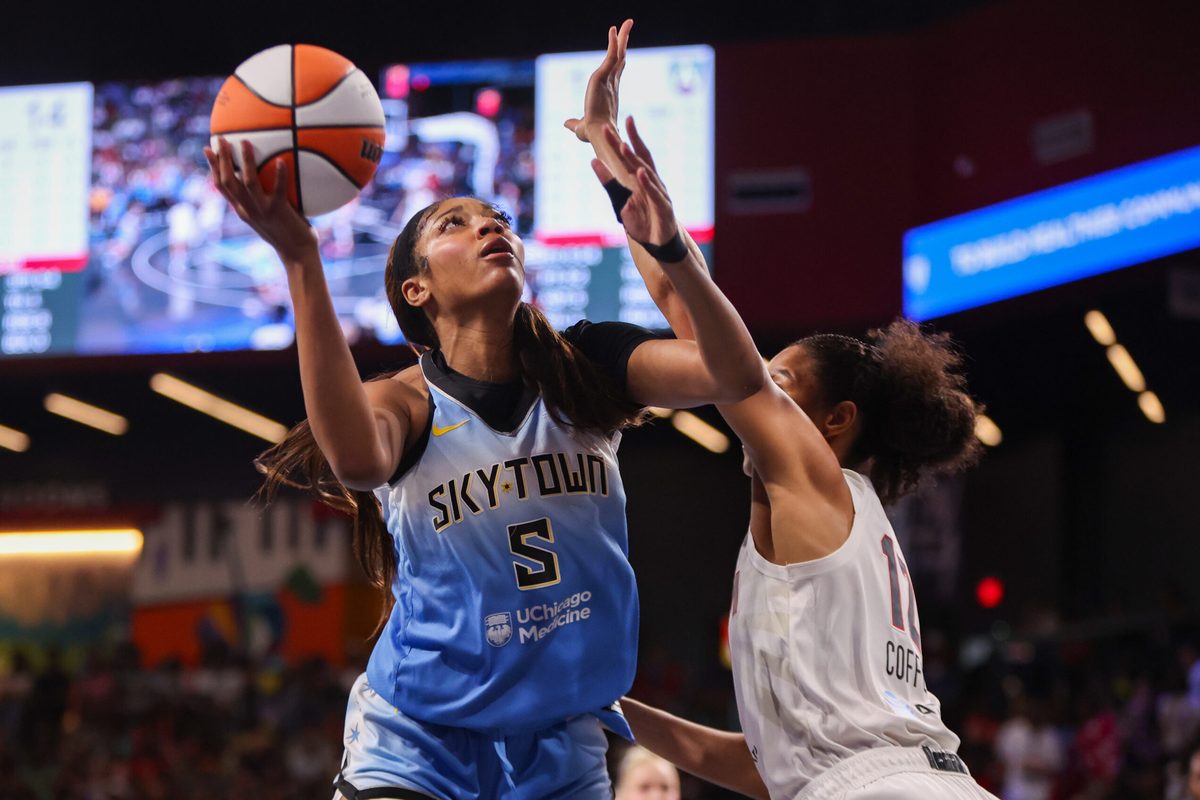 Jun 22, 2025; College Park, Georgia, USA; Chicago Sky forward Angel Reese (5) shoots past Atlanta Dream forward Nia Coffey (12) in the first quarter at Gateway Center Arena at College Park. Mandatory Credit: Brett Davis-Imagn Images