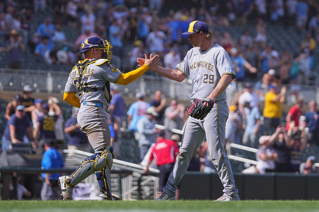 Jun 22, 2025; Minneapolis, Minnesota, USA; Milwaukee Brewers pitcher Trevor Megill (29) celebrates the win with catcher William Contreras (24) against the Minnesota Twins after the game at Target Field. Mandatory Credit: Brad Rempel-Imagn Images
