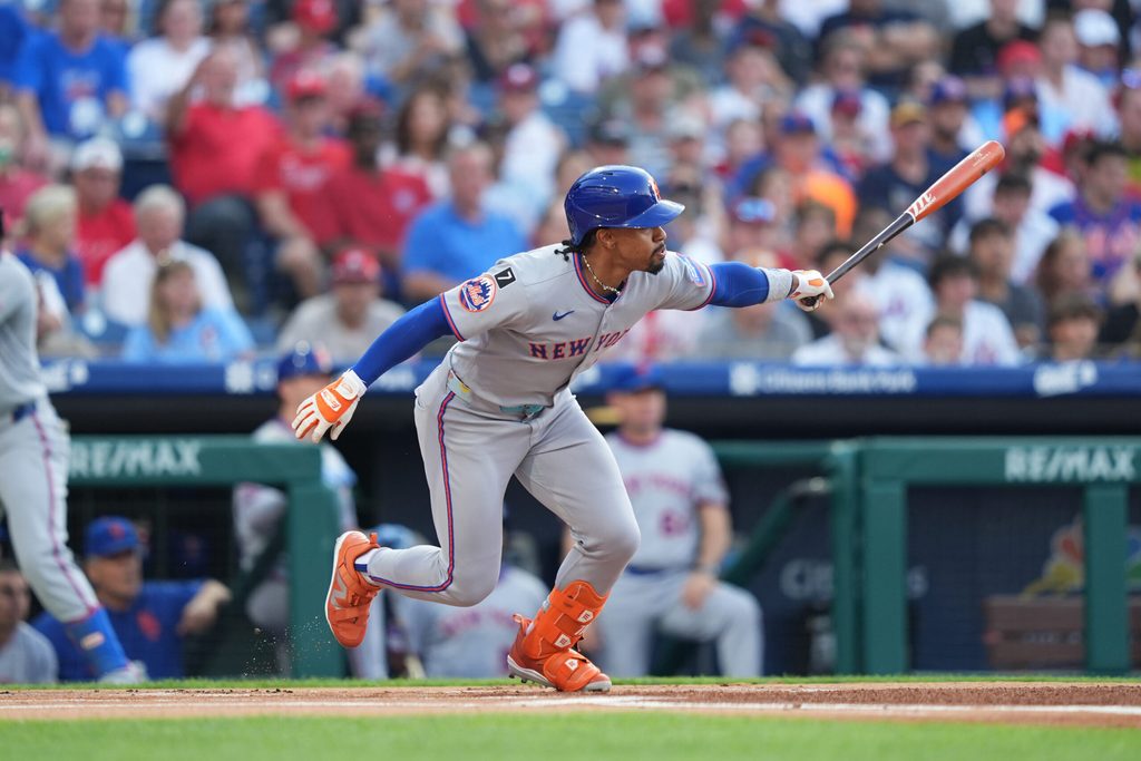Jun 22, 2025; Philadelphia, Pennsylvania, USA; New York Mets infielder Francisco Lindor (12) hits a single against the Philadelphia Phillies in the first inning at Citizens Bank Park. Mandatory Credit: Kyle Ross-Imagn Images