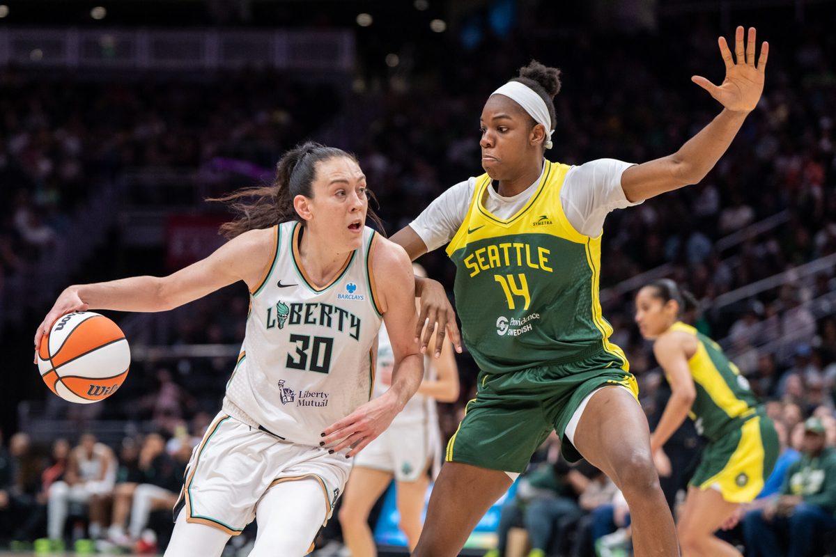 Jun 22, 2025; Seattle, Washington, USA; New York Libertyforward Breanna Stewart (30) dribbles the ball against Seattle Storm center Dominique Malonga (14) during the second half at Climate Pledge Arena. Mandatory Credit: Stephen Brashear-Imagn Images