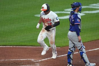 Jun 23, 2025; Baltimore, Maryland, USA; Baltimore Orioles outfielder Ramon Laureano (12) scores during the seventh inning against the Texas Rangers at Oriole Park at Camden Yards. Mandatory Credit: Mitch Stringer-Imagn Images