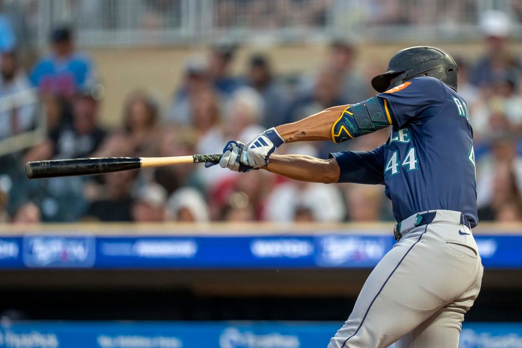 Jun 23, 2025; Minneapolis, Minnesota, USA; Seattle Mariners center fielder Julio Rodriguez (44) hits a two run double against the Minnesota Twins in the ninth inning at Target Field. Mandatory Credit: Jesse Johnson-Imagn Images