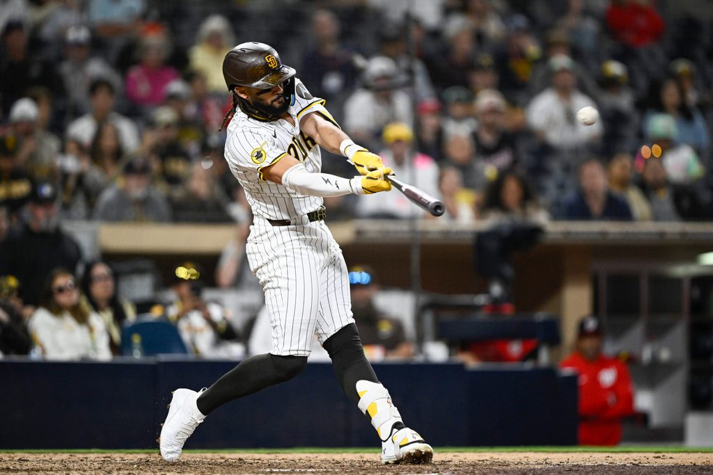 Jun 23, 2025; San Diego, California, USA; San Diego Padres right fielder Fernando Tatis Jr. (23) hits a solo home run during the ninth inning against the Washington Nationals at Petco Park. Mandatory Credit: Denis Poroy-Imagn Images