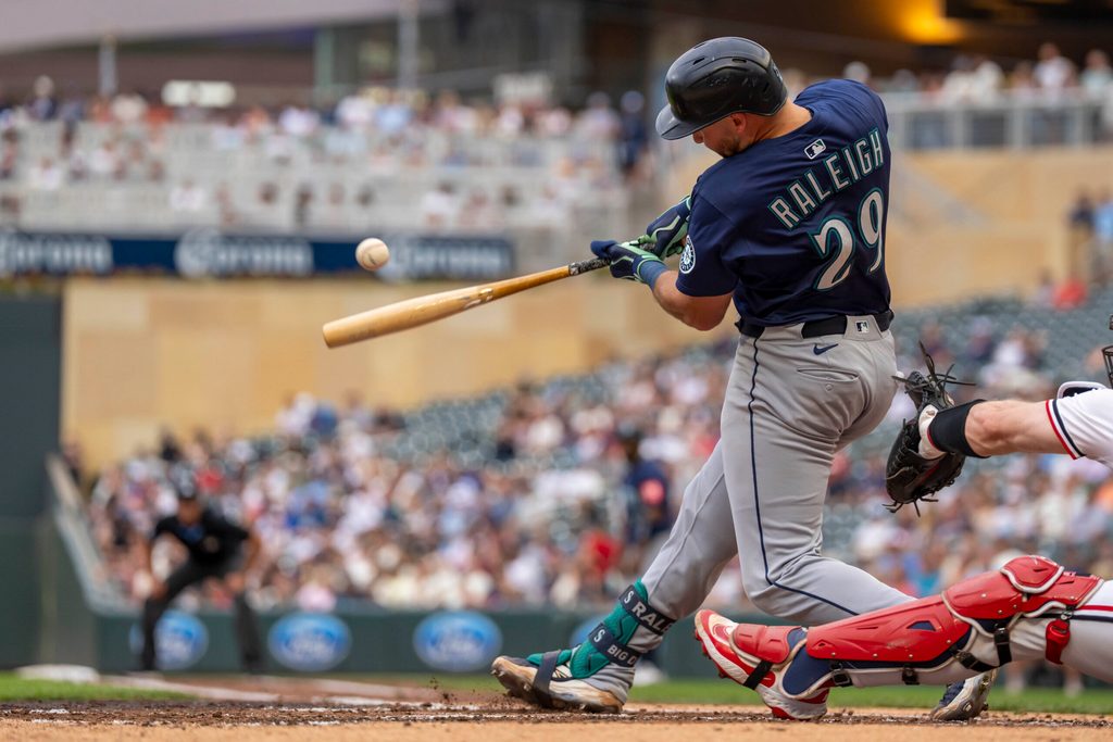 Jun 24, 2025; Minneapolis, Minnesota, USA; Seattle Mariners catcher Cal Raleigh (29) hits a RBI single against the Minnesota Twins in the third inning at Target Field. Mandatory Credit: Jesse Johnson-Imagn Images