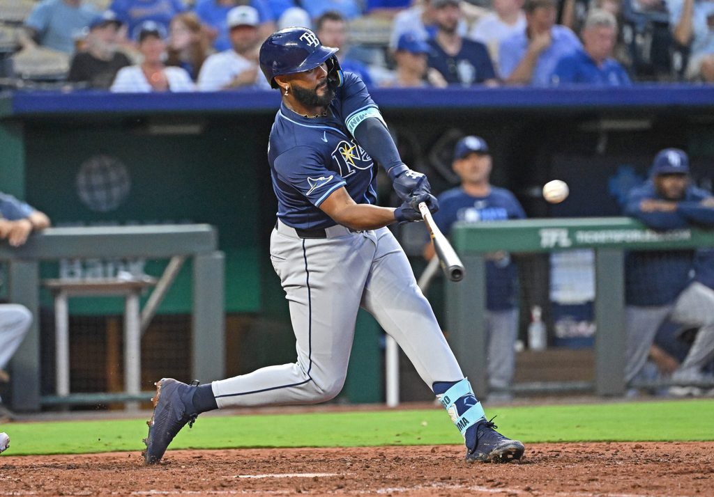 Jun 24, 2025; Kansas City, Missouri, USA; Tampa Bay Rays right fielder Junior Caminero (13) doubles in the eighth inning against the Kansas City Royals at Kauffman Stadium. Mandatory Credit: Peter Aiken-Imagn Images