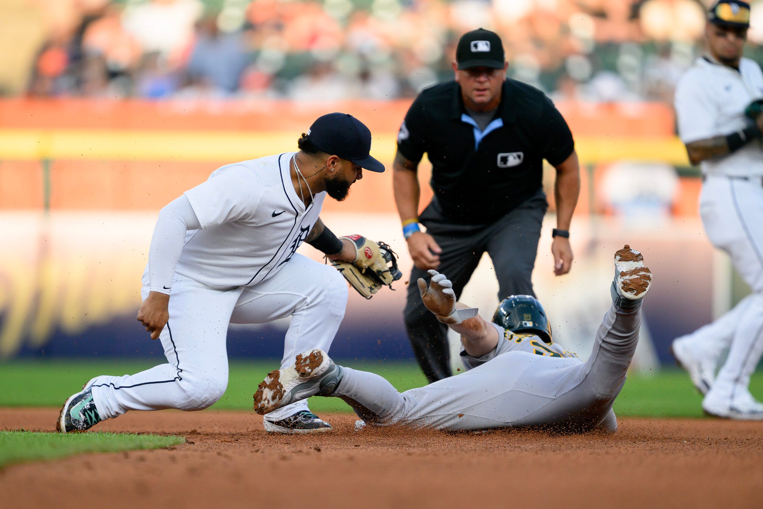 Jun 25, 2025; Detroit, Michigan, USA; Detroit Tigers second baseman Gleyber Torres (25) tags out Athletics left fielder Tyler Soderstrom (21) trying to steal second base in the fifth inning at Comerica Park. Mandatory Credit: Lon Horwedel-Imagn Images