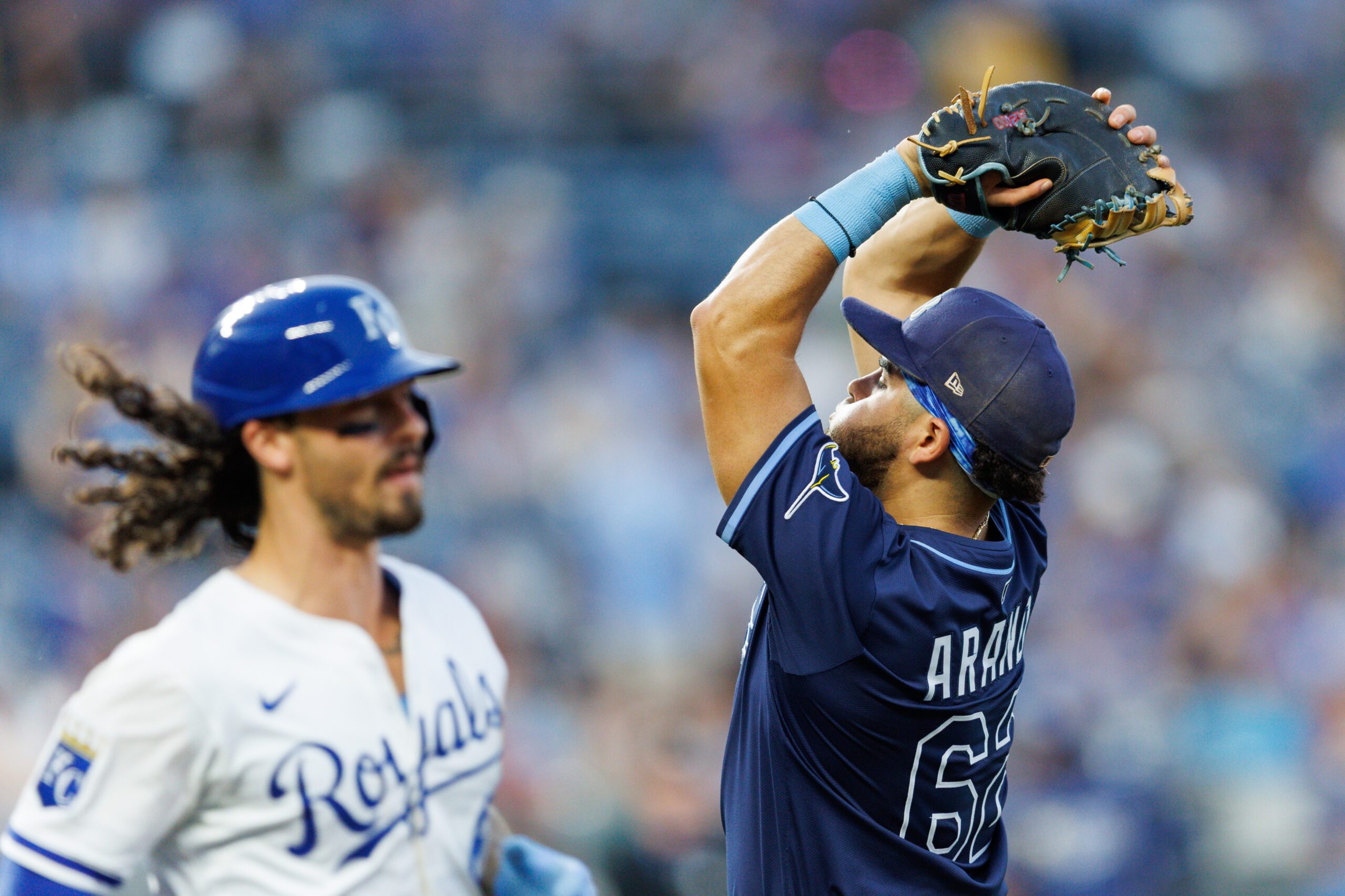 Jun 25, 2025; Kansas City, Missouri, USA; Tampa Bay Rays first baseman Jonathan Aranda (62) fields a fly ball during the eighth inning against the Kansas City Royals at Kauffman Stadium. Mandatory Credit: William Purnell-Imagn Images