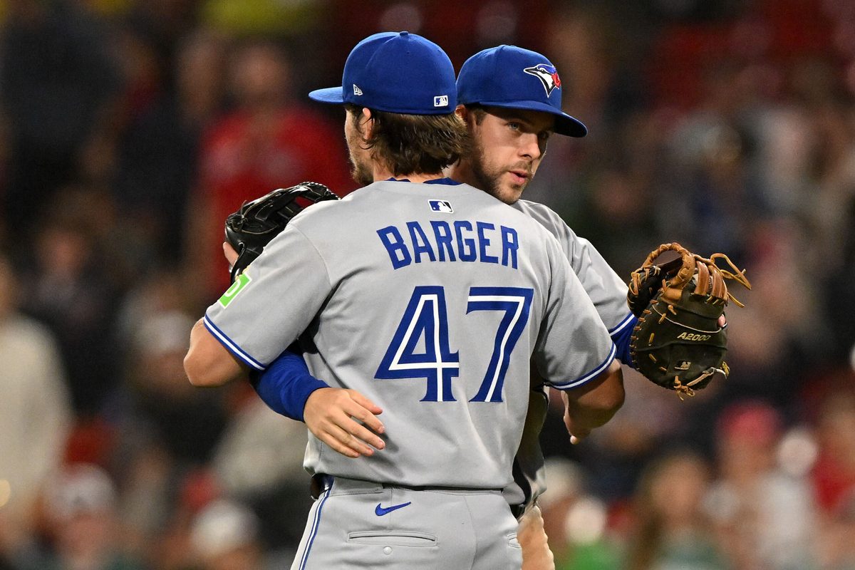 Jun 27, 2025; Boston, Massachusetts, USA; Toronto Blue Jays third baseman Addison Barger (47) celebrates with third baseman Ernie Clement (22) after a game against the Boston Red Sox at Fenway Park. Mandatory Credit: Brian Fluharty-Imagn Images