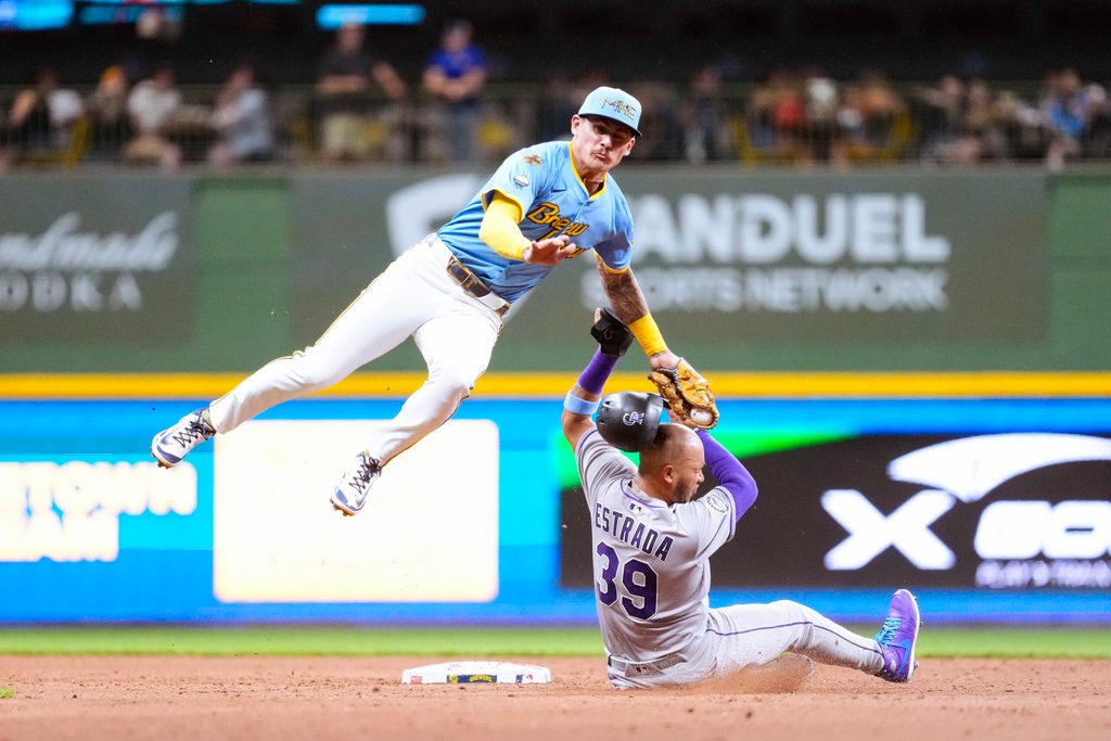 Jun 27, 2025; Milwaukee, Wisconsin, USA; Colorado Rockies second baseman Thairo Estrada (39) is tagged out but Milwaukee Brewers shortstop Joey Ortiz (3) while trying to steal second base during the seventh inning at American Family Field. Mandatory Credit: Jeff Hanisch-Imagn Images