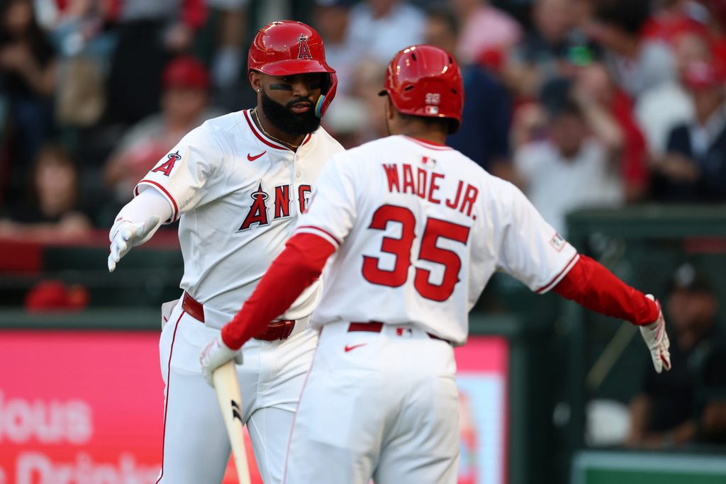 Jun 27, 2025; Anaheim, California, USA; Los Angeles Angels center fielder Jo Adell (7, left) is greeted by right fielder LaMonte Wade Jr. (35) after hitting a home run during the second inning against the Washington Nationals at Angel Stadium. Mandatory Credit: Kiyoshi Mio-Imagn Images