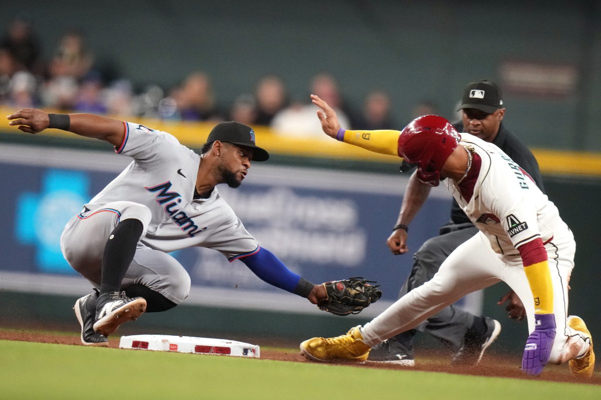 Arizona Diamondbacks base runner Lourdes Gurriel Jr. (12) is tagged out on a steal attempt at second base by Miami Marlins ifielder Otto Lopez (6) at Chase Field on Saturday, June 28, 2025.