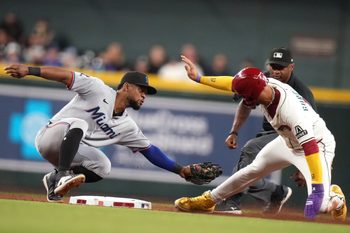 Arizona Diamondbacks base runner Lourdes Gurriel Jr. (12) is tagged out on a steal attempt at second base by Miami Marlins ifielder Otto Lopez (6) at Chase Field on Saturday, June 28, 2025.
