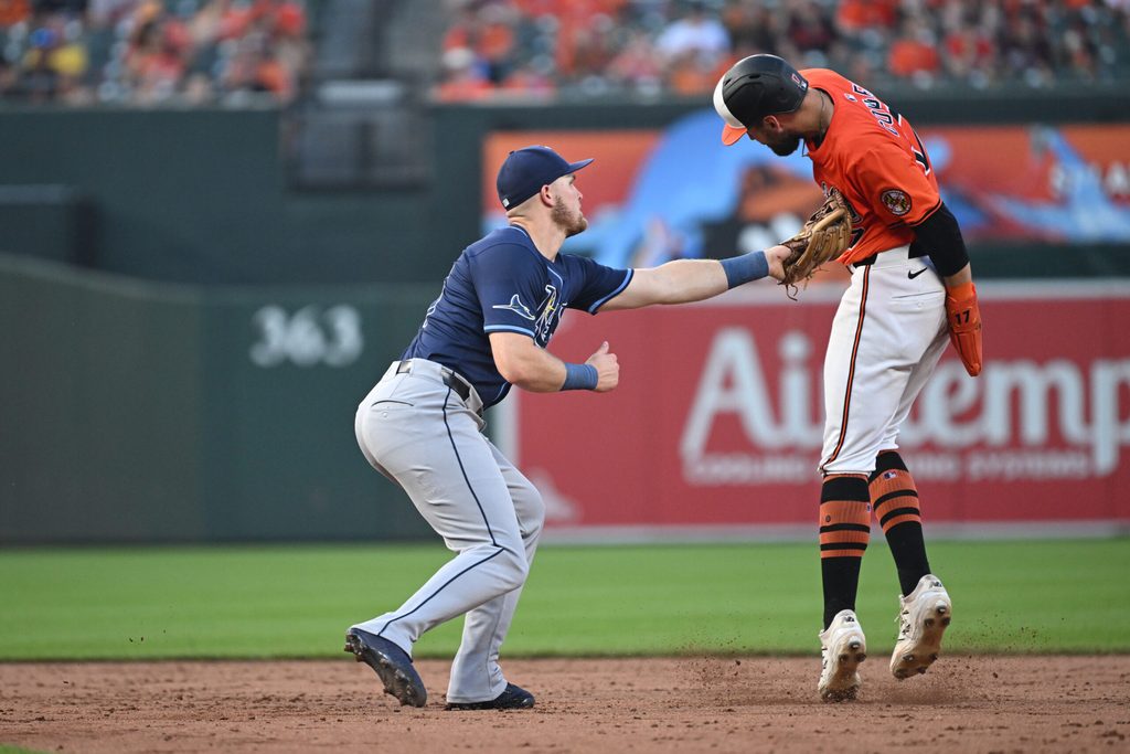 Jun 28, 2025; Baltimore, Maryland, USA; Tampa Bay Rays first baseman Curtis Mead (25) tags out Baltimore Orioles left fielder Colton Cowser (17) at second base during the ninth inning at Oriole Park at Camden Yards. Mandatory Credit: Rafael Suanes-Imagn Images