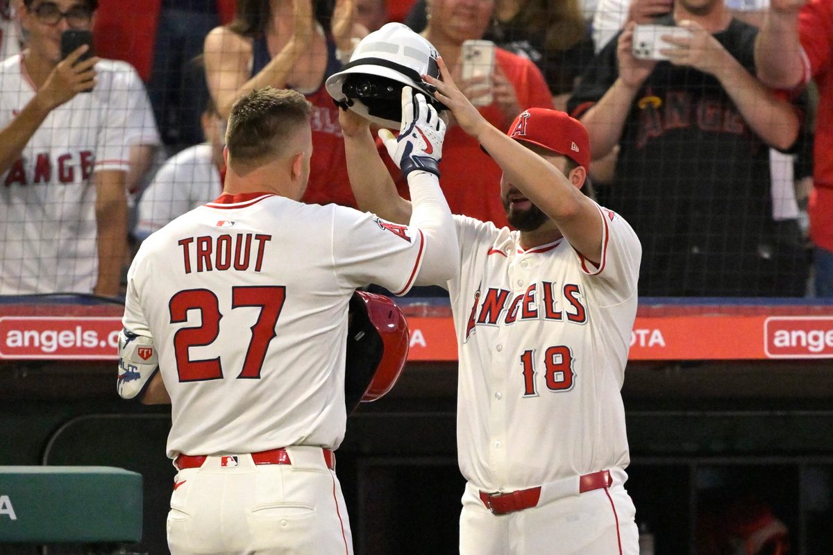 Jun 28, 2025; Anaheim, California, USA; Los Angeles Angels right fielder Mike Trout (27) is is greeted at the dugout by first baseman Nolan Schanuel (18) after hitting a solo home run in the seventh inning against the Washington Nationals at Angel Stadium. Mandatory Credit: Jayne Kamin-Oncea-Imagn Images