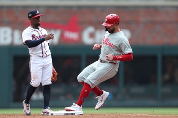 Jun 29, 2025; Cumberland, Georgia, Philadelphia Phillies left fielder Kyle Schwarber (12) steals second base next to Atlanta Braves second baseman Ozzie Albies (1) during the fifth inning at Truist Park. Mandatory Credit: Mady Mertens-Imagn Images