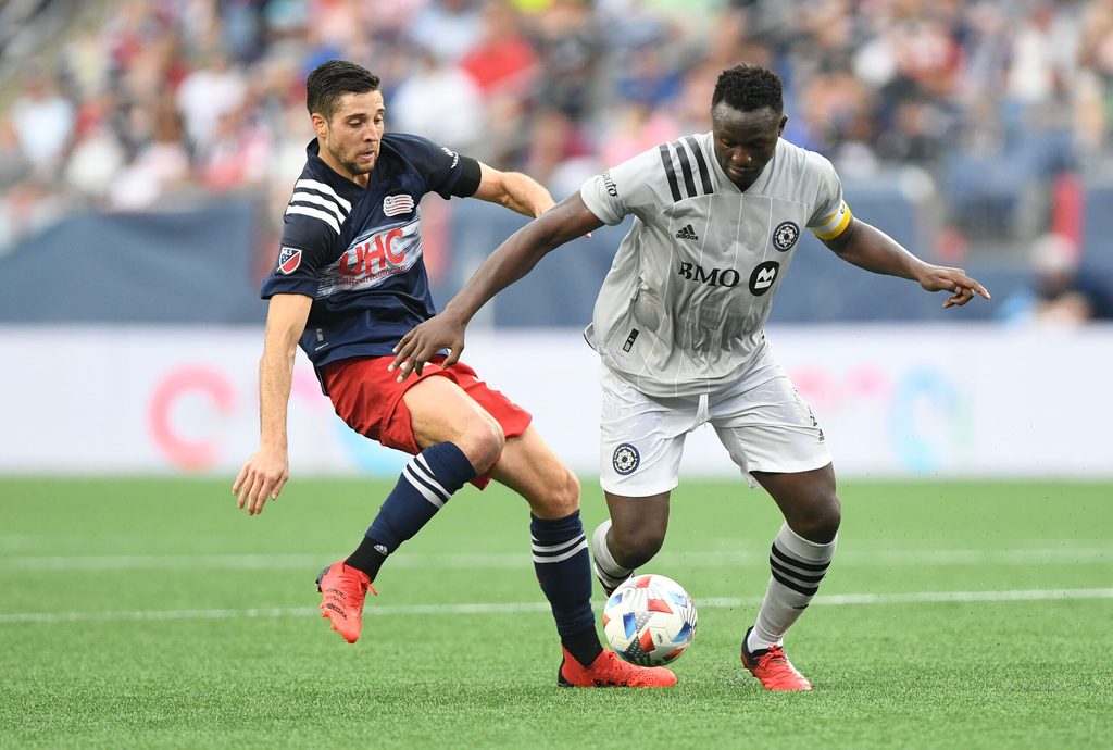 Jul 25, 2021; Foxborough, Massachusetts, USA; CF Montreal midfielder Victor Wanyama (2) controls the ball against New England Revolution midfielder Matt Polster (8) during the first half at Gillette Stadium. Mandatory Credit: Brian Fluharty-Imagn Images