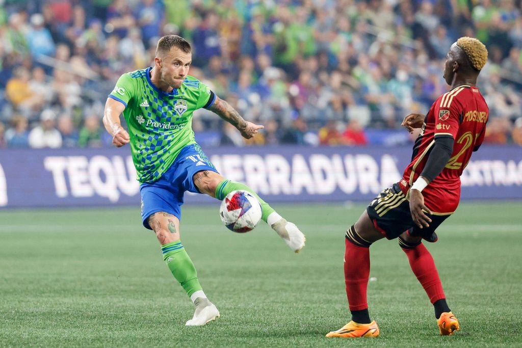 Aug 20, 2023; Seattle, Washington, USA; Seattle Sounders FC midfielder Albert Rusnak (11) shoots a deflection before Atlanta United midfielder Edwin Mosquera (21) can reach it during the second half at Lumen Field. Mandatory Credit: Joe Nicholson-Imagn Images
