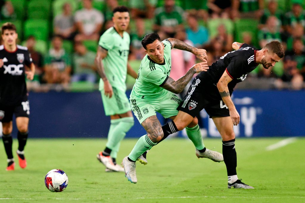 Oct 4, 2023; Austin, Texas, USA; Austin FC forward Sebastian Driussi (10) battles for the ball after the game D.C. United midfielder Mateusz Klich (43) during the game at Q2 Stadium. Mandatory Credit: Erich Schlegel-Imagn Images