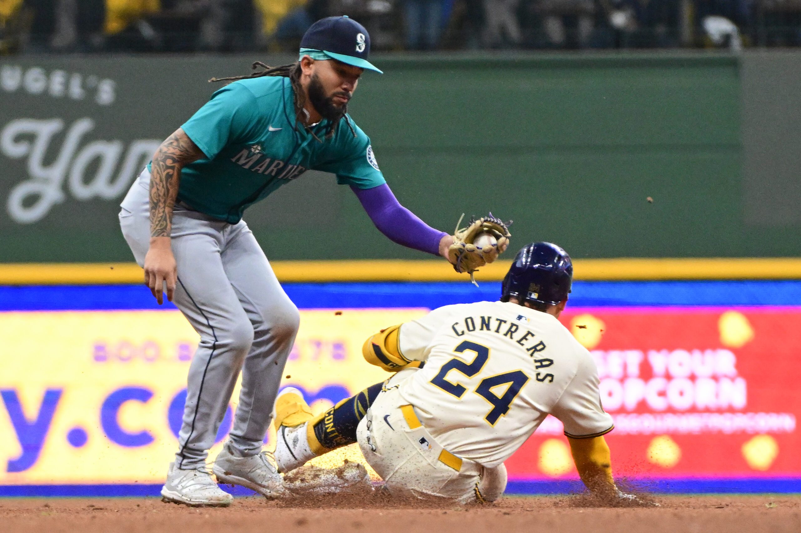 Apr 7, 2024; Milwaukee, Wisconsin, USA; Seattle Mariners shortstop J.P. Crawford (3) tags out Milwaukee Brewers catcher William Contreras (24) trying to stretch a single in the fourth inning at American Family Field. Mandatory Credit: Benny Sieu-Imagn Images