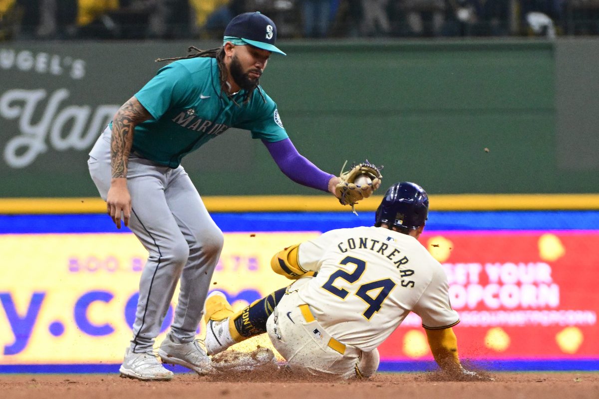 Apr 7, 2024; Milwaukee, Wisconsin, USA; Seattle Mariners shortstop J.P. Crawford (3) tags out Milwaukee Brewers catcher William Contreras (24) trying to stretch a single in the fourth inning at American Family Field. Mandatory Credit: Benny Sieu-Imagn Images