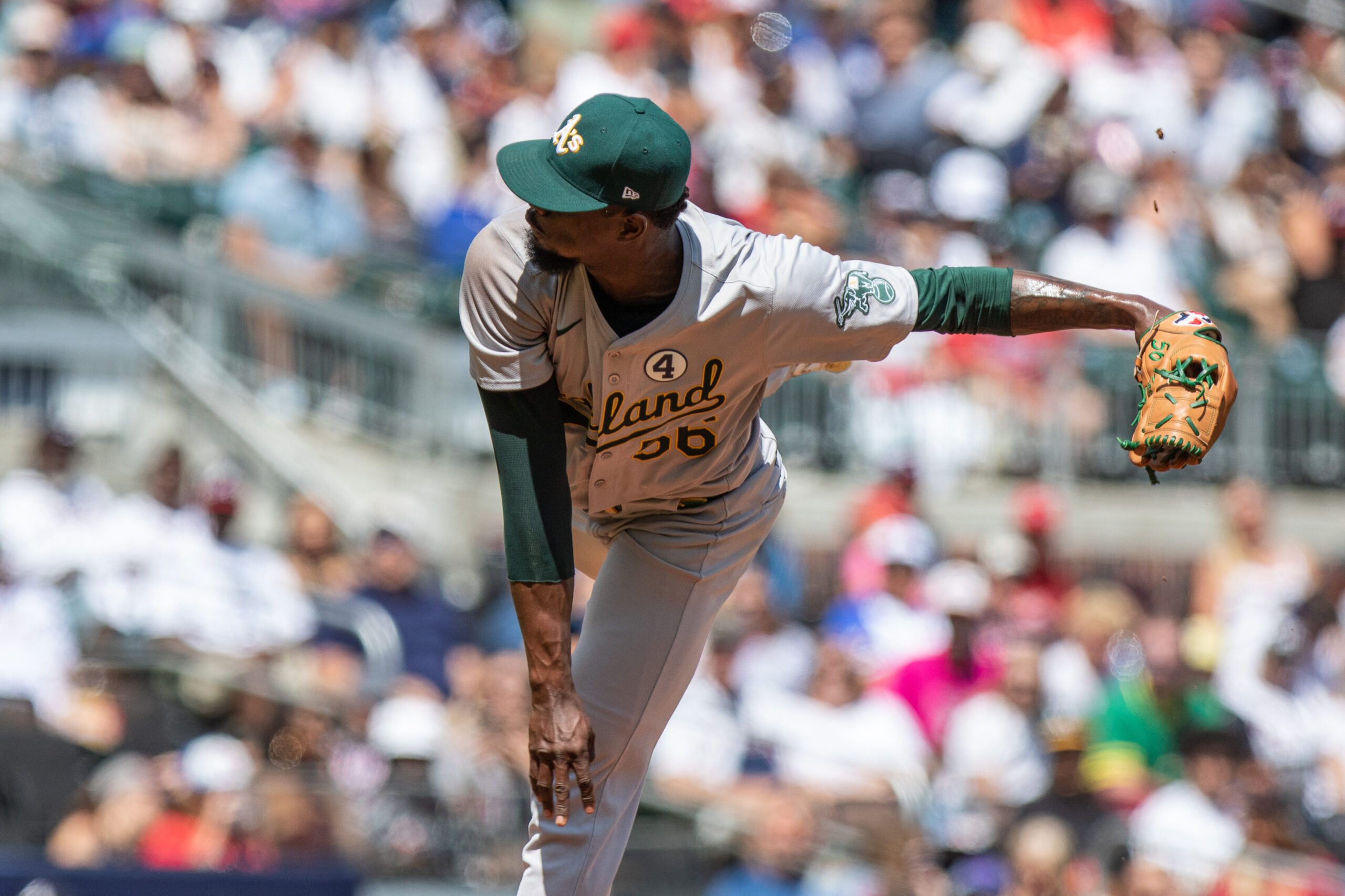 Jun 2, 2024; Cumberland, Georgia, USA; Oakland Athletics pitcher Dany Jiménez (56) pitches the ball against the Atlanta Braves during the eighth inning at Truist Park. Mandatory Credit: Jordan Godfree-Imagn Images