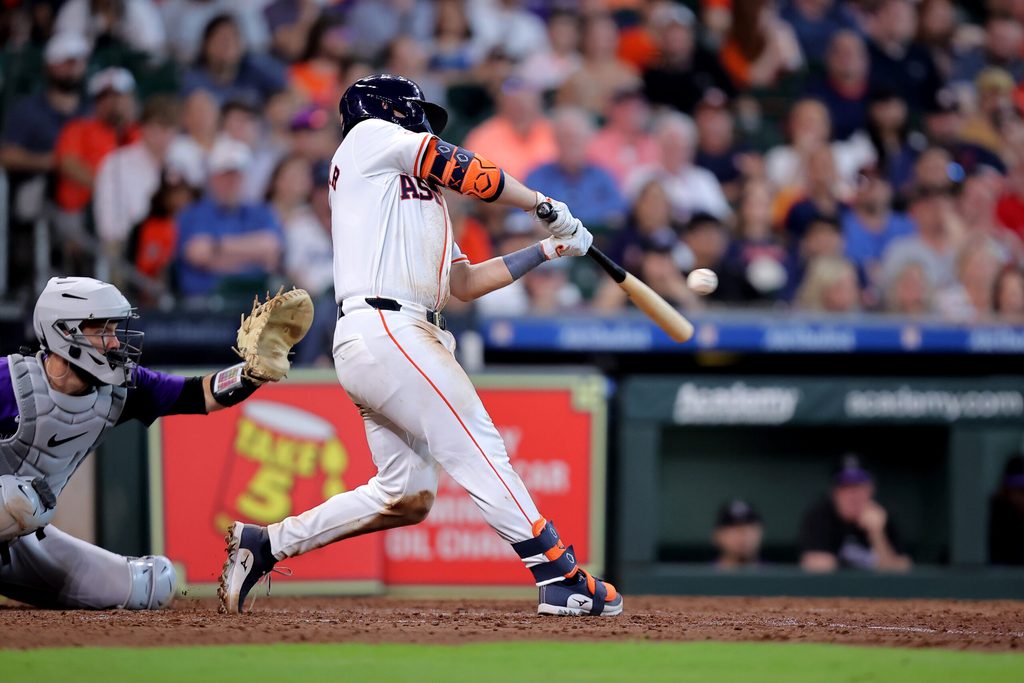 Jun 26, 2024; Houston, Texas, USA; Houston Astros catcher Cesar Salazar (18) hits an RBI sacrifice fly against the Colorado Rockies during the seventh inning at Minute Maid Park. Mandatory Credit: Erik Williams-Imagn Images