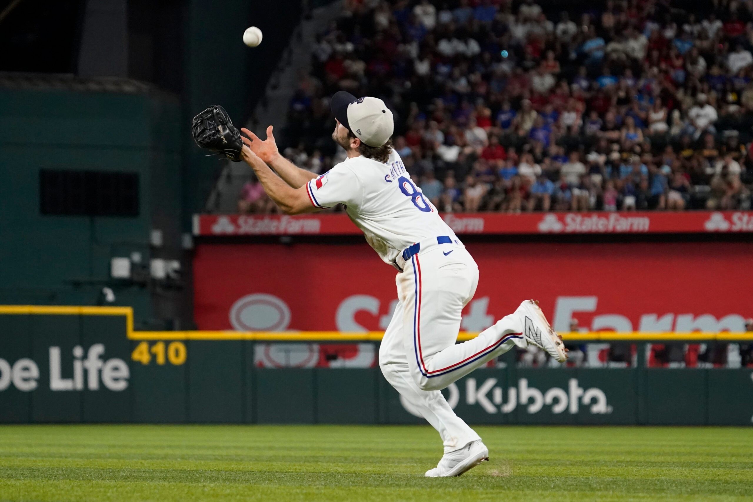 Jul 4, 2024; Arlington, Texas, USA; Texas Rangers third base Josh Smith (8) makes an over the shoulder catch of a pop fly during the ninth inning against the San Diego Padres at Globe Life Field. Mandatory Credit: Raymond Carlin III-Imagn Images