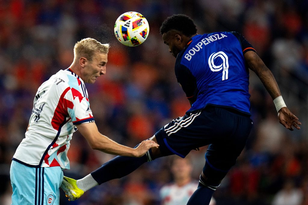 Chicago Fire defender Tobias Salquist (14) heads the ball away from FC Cincinnati forward Aaron Boupendza (9) in the second half of the MLS match at TQL Stadium in Cincinnati on Wednesday, July 17, 2024.