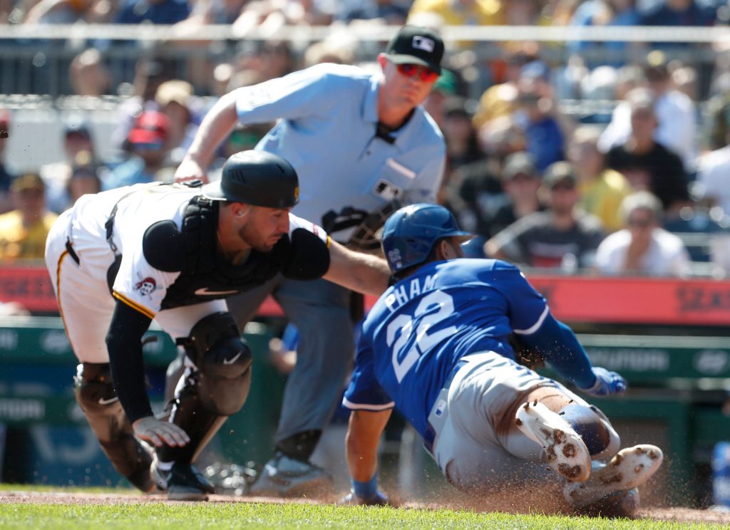 Sep 15, 2024; Pittsburgh, Pennsylvania, USA; Pittsburgh Pirates catcher Joey Bart (14) tags Kansas City Royals outfielder Tommy Pham (22) out at home plate attempting to score a run during the third inning at PNC Park. Mandatory Credit: Charles LeClaire-Imagn Images