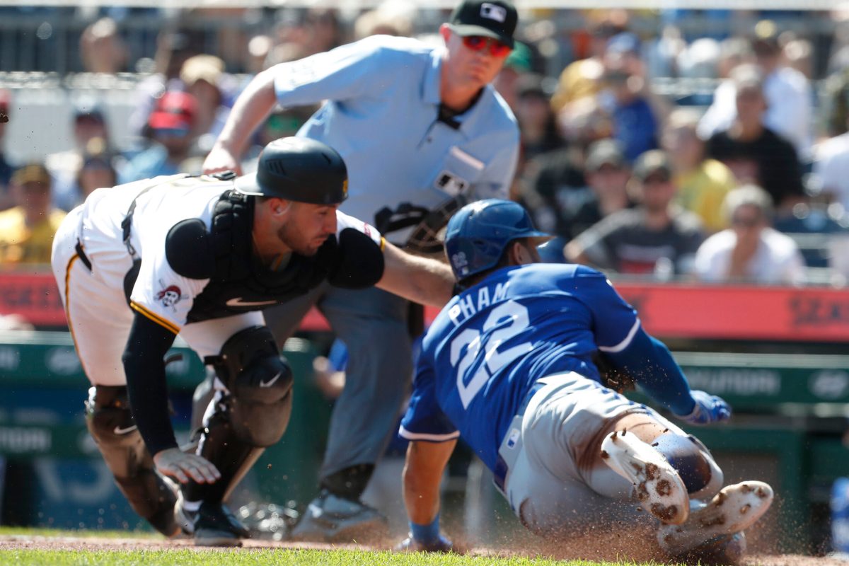 Sep 15, 2024; Pittsburgh, Pennsylvania, USA; Pittsburgh Pirates catcher Joey Bart (14) tags Kansas City Royals outfielder Tommy Pham (22) out at home plate attempting to score a run during the third inning at PNC Park. Mandatory Credit: Charles LeClaire-Imagn Images