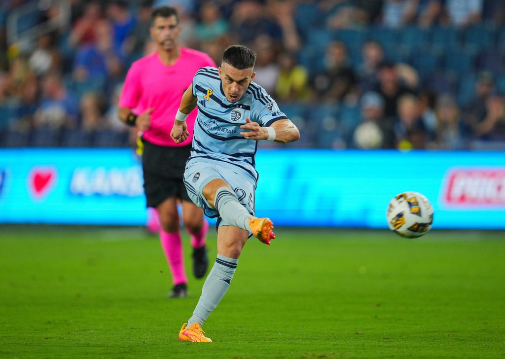 Sep 18, 2024; Kansas City, Kansas, USA; Sporting Kansas City midfielder Erik Thommy (26) shoots during the second half against the Colorado Rapids at Children's Mercy Park. Mandatory Credit: Jay Biggerstaff-Imagn Images