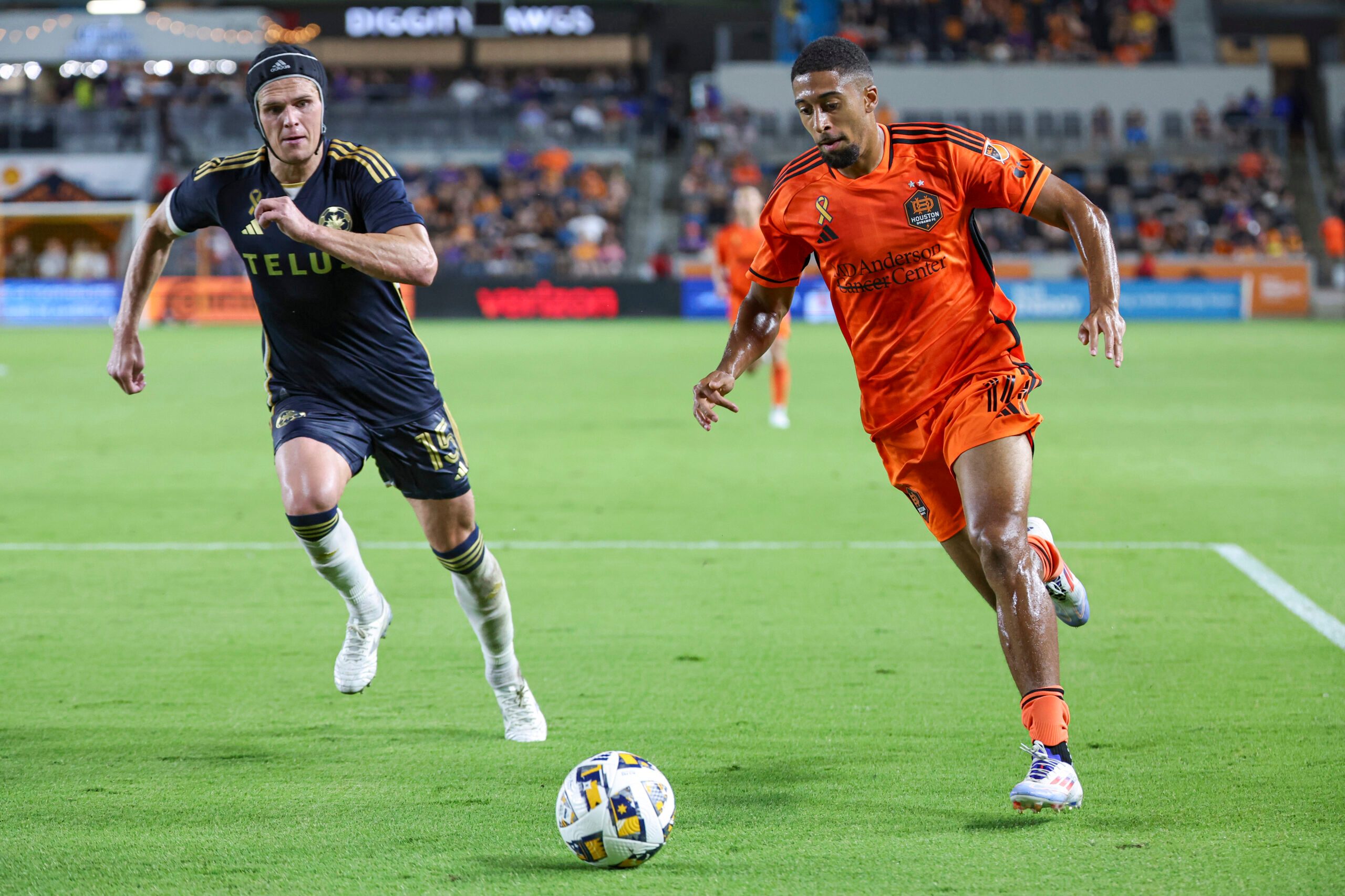 Sep 18, 2024; Houston, Texas, USA; Houston Dynamo FC defender McKinze Gaines (14) in action as Vancouver Whitecaps FC defender Bjorn Utvik (15) defends during the match at Shell Energy Stadium. Mandatory Credit: Troy Taormina-Imagn Images