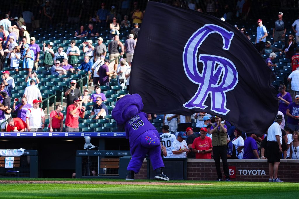 Sep 26, 2024; Denver, Colorado, USA; Colorado Rockies mascot Dinger celebrate defeating the St. Louis Cardinals at Coors Field. Mandatory Credit: Ron Chenoy-Imagn Images