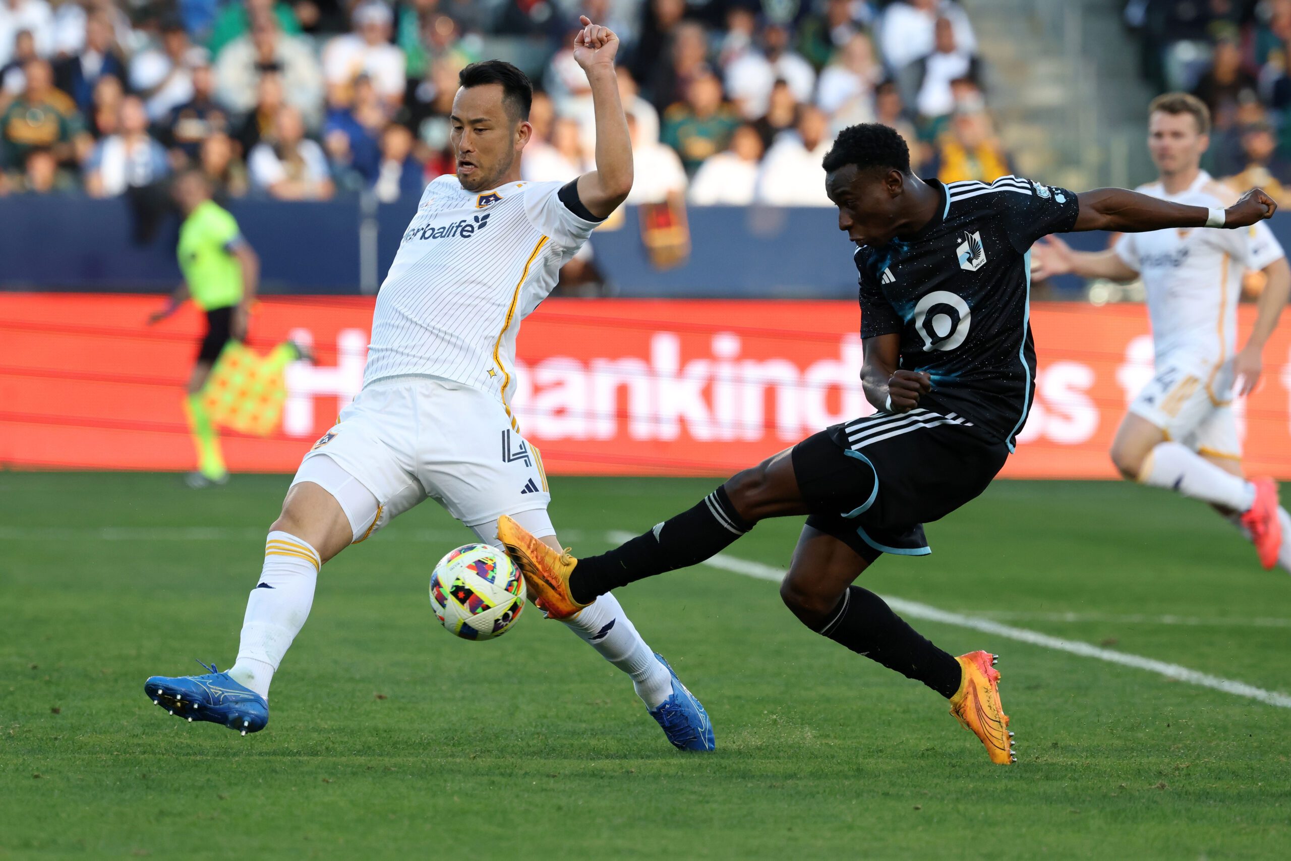 Nov 24, 2024; Carson, California, USA; Minnesota United forward Kelvin Yeboah (9) shoots the ball as LA Galaxy defender Maya Yoshida (4) defends during the first half at Dignity Health Sports Park. Mandatory Credit: Kiyoshi Mio-Imagn Images