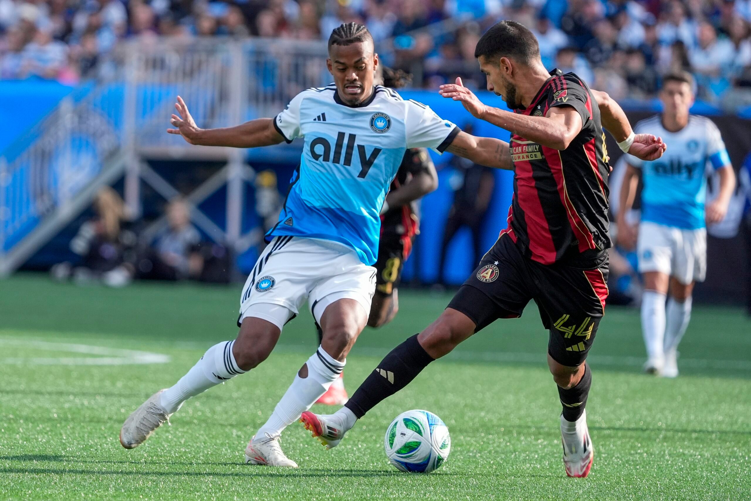 Mar 1, 2025; Charlotte, North Carolina, USA; Charlotte FC forward Kerwin Vargas (18) and Atlanta United defender Luis Abram (44) battle for the ball during the second half  at Bank of America Stadium. Mandatory Credit: Jim Dedmon-Imagn Images