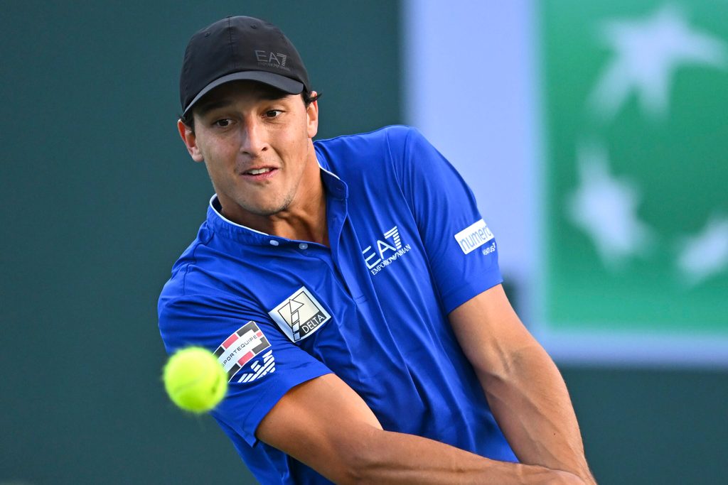 Mar 6, 2025; Indian Wells, CA, USA; Luciano Darderi (ITA) hits a ball against Hugo Gaston (FRA) in the BNP Paribas Open at the Indian Well Tennis Garden. Mandatory Credit: Jonathan Hui-Imagn Images