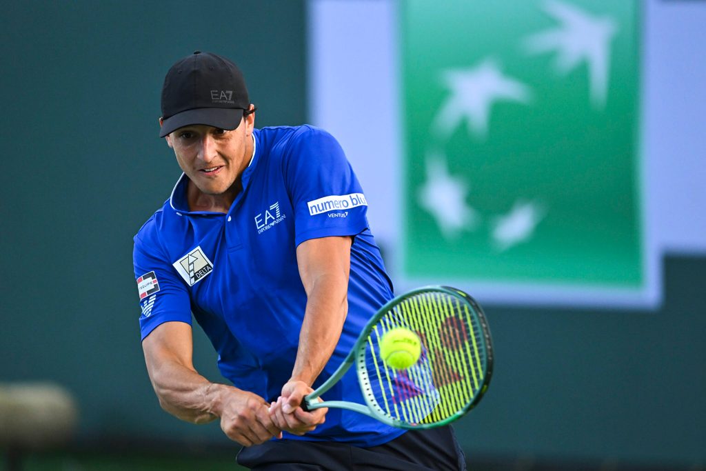 Mar 6, 2025; Indian Wells, CA, USA; Luciano Darderi (ITA) hits a ball against Hugo Gaston (FRA) in the BNP Paribas Open at the Indian Well Tennis Garden. Mandatory Credit: Jonathan Hui-Imagn Images