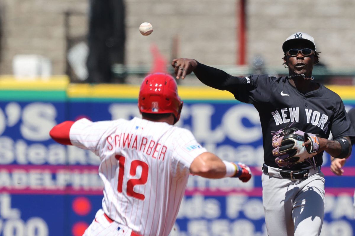Mar 19, 2025; Clearwater, Florida, USA; New York Yankees third base Jazz Chisholm Jr. (13) forces out Philadelphia Phillies designated hitter Kyle Schwarber (12) and throws the ball to first base for a double play during the third inning at BayCare Ballpark. Mandatory Credit: Kim Klement Neitzel-Imagn Images