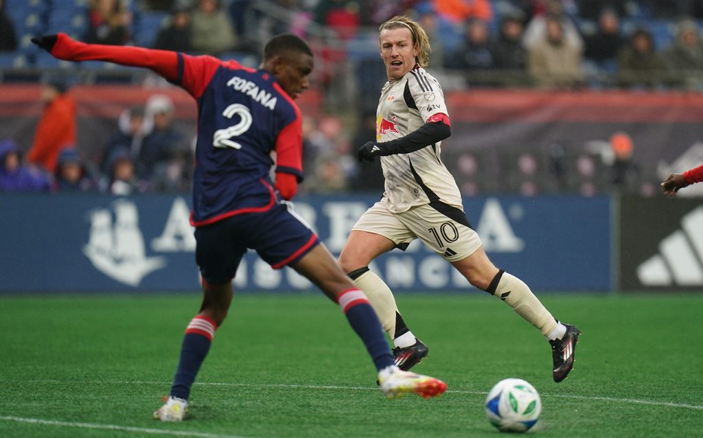 Mar 29, 2025; Foxborough, Massachusetts, USA; New York Red Bulls midfielder Emil Forsberg (10) passes the ball against New England Revolution defender Mamadou Fofana (2) in the second half at Gillette Stadium. Mandatory Credit: David Butler II-Imagn Images