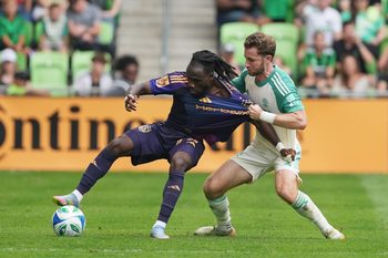 Apr 19, 2025; Austin, Texas, USA; LA Galaxy forward Joseph Paintsil (28) dribbles the ball while defended by Austin FC defender Jon Gallagher (17) during the second half at Q2 Stadium. Mandatory Credit: Scott Wachter-Imagn Images