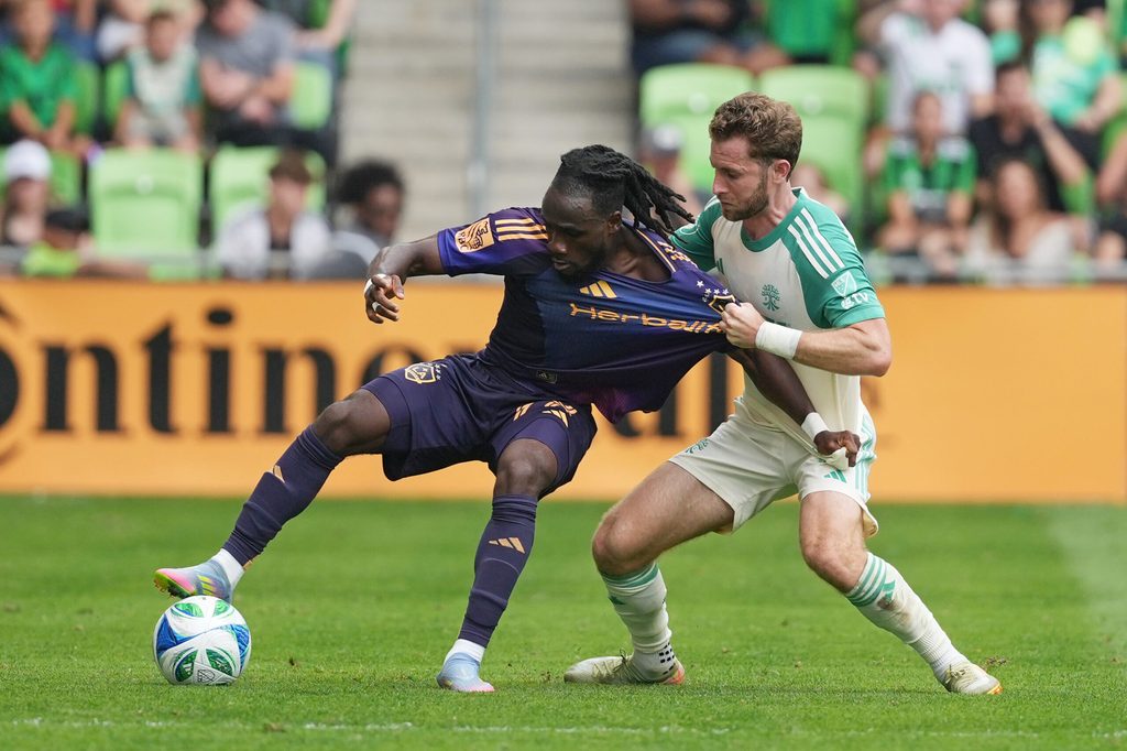 Apr 19, 2025; Austin, Texas, USA; LA Galaxy forward Joseph Paintsil (28) dribbles the ball while defended by Austin FC defender Jon Gallagher (17) during the second half at Q2 Stadium. Mandatory Credit: Scott Wachter-Imagn Images
