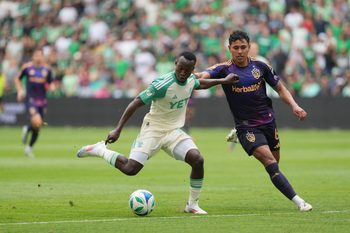 Apr 19, 2025; Austin, Texas, USA; Austin FC forward Osman Bukari (11) dribbles while defended by LA Galaxy  midfielder Edwin Cerrillo (6) during the second half at Q2 Stadium. Mandatory Credit: Scott Wachter-Imagn Images