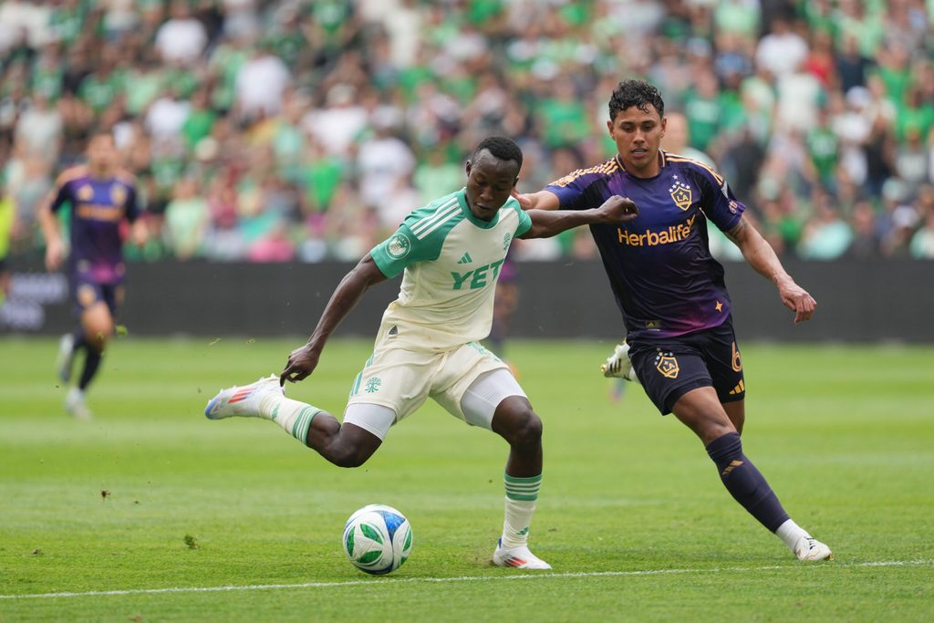 Apr 19, 2025; Austin, Texas, USA; Austin FC forward Osman Bukari (11) dribbles while defended by LA Galaxy midfielder Edwin Cerrillo (6) during the second half at Q2 Stadium. Mandatory Credit: Scott Wachter-Imagn Images