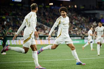 Apr 19, 2025; Portland, Oregon, USA; Los Angeles FC forward David Martinez (30) celebrates with Los Angeles FC forward Denis Bouanga (99) after scoring a goal during the second half against the Portland Timbers at Providence Park. Mandatory Credit: Troy Wayrynen-Imagn Images