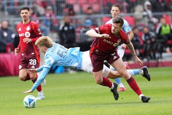 Apr 26, 2025; Toronto, Ontario, CAN; New York City midfielder Keaton Parks (55) battles for the ball withToronto FC defender Kevin Long (5) during the first half at BMO Field. Mandatory Credit: Nick Turchiaro-Imagn Images