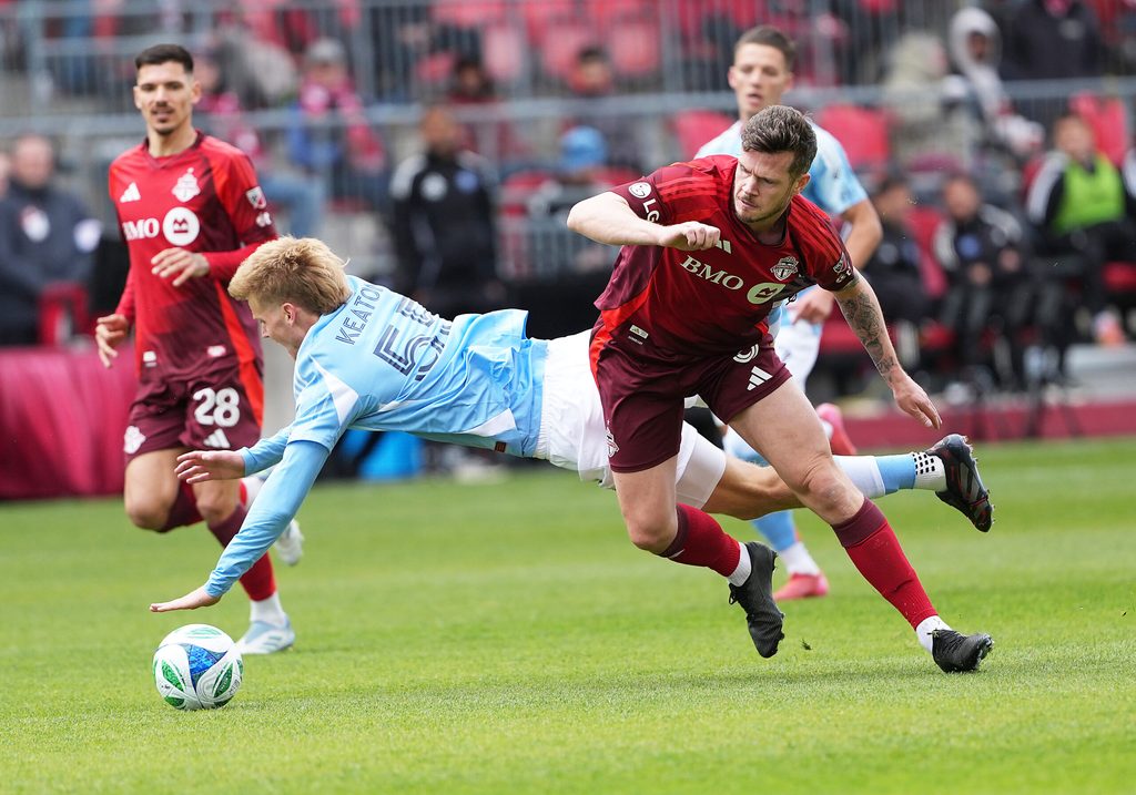 Apr 26, 2025; Toronto, Ontario, CAN; New York City midfielder Keaton Parks (55) battles for the ball withToronto FC defender Kevin Long (5) during the first half at BMO Field. Mandatory Credit: Nick Turchiaro-Imagn Images