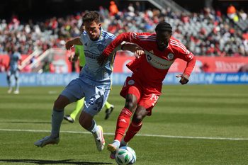 May 10, 2025; Chicago, Illinois, USA; Atlanta United defender Noah Cobb (24) and Chicago Fire forward Jonathan Bamba (19) battle for control of the ball during the second half at Soldier Field. Mandatory Credit: Talia Sprague-Imagn Images