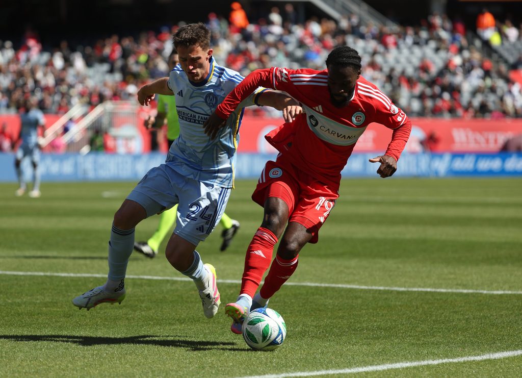 May 10, 2025; Chicago, Illinois, USA; Atlanta United defender Noah Cobb (24) and Chicago Fire forward Jonathan Bamba (19) battle for control of the ball during the second half at Soldier Field. Mandatory Credit: Talia Sprague-Imagn Images