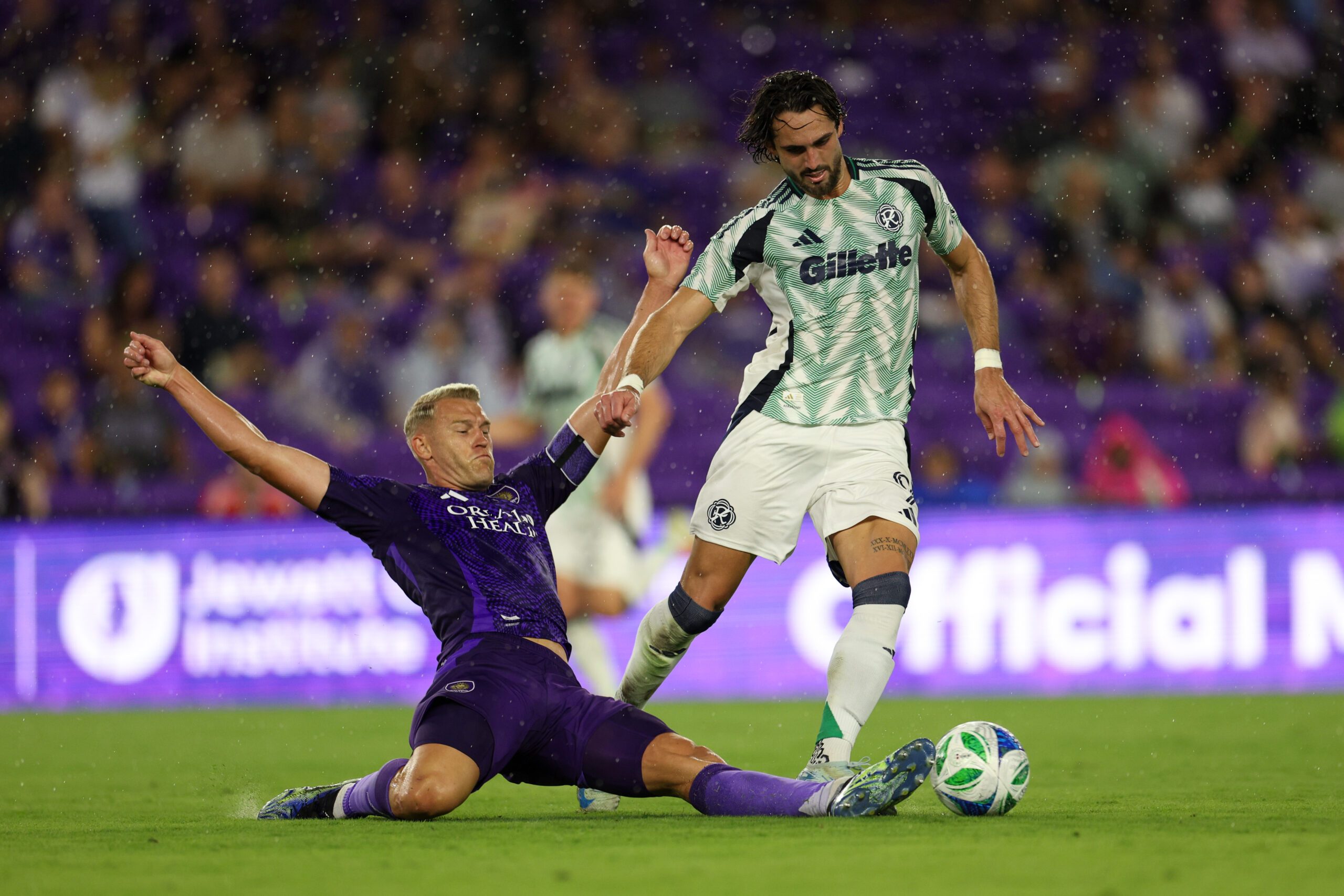 May 10, 2025; Orlando, Florida, USA; Orlando City defender Robin Jansson (6) tackles the ball past New England Revolution forward Leonardo Campana (9) in the first half at Inter&Co Stadium. Mandatory Credit: Nathan Ray Seebeck-Imagn Images