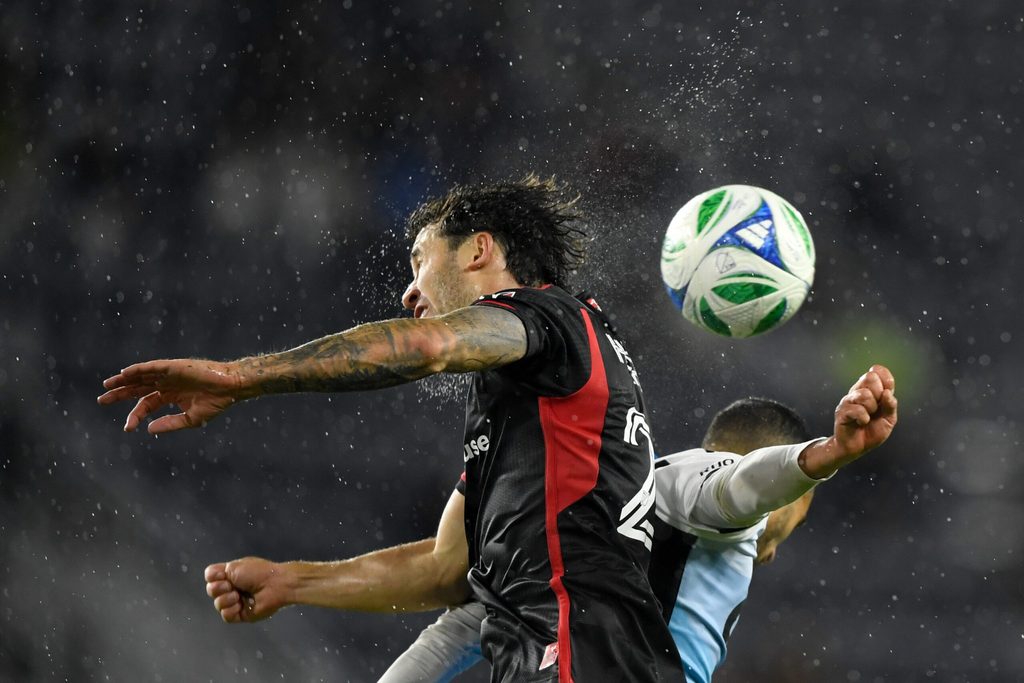 May 21, 2025; Washington, District of Columbia, USA; D.C. United defender Aaron Herrera (22) and Charlotte FC forward Liel Abada (11) go for a header during the second half of the game at Audi Field. Mandatory Credit: Hannah Foslien-Imagn Images